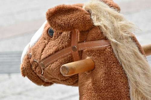 horse toy brown object handle outdoor mascot outdoors  objects