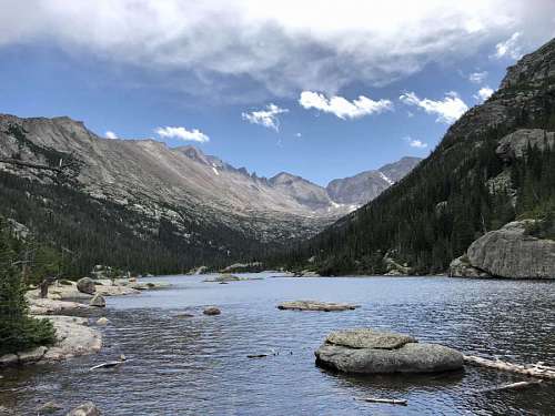 cloudy peak glacier cloudy cloudiness mountainside scenic mountain valley range lake water
