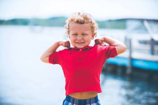 gymnastics Portrait of a blonde boy showing his muscles