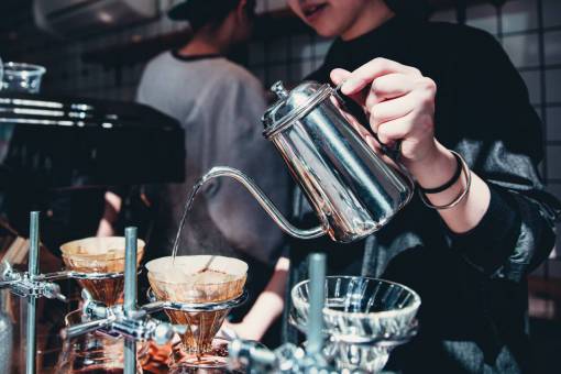 elaborate barista  pouring  coffee  kettle  woman  restaurant  beverage
