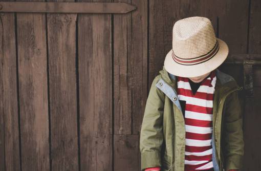 thoughtful young  child  hat  stripes  red  white  jacket