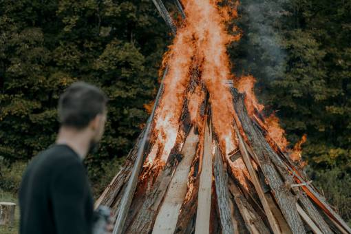 fire natural phenomenon outdoors nature flame man;forest;stack of wood;fire men