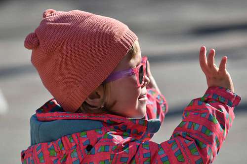 cheerful enjoyment happiness child fun playful sunglasses hat pretty winter
