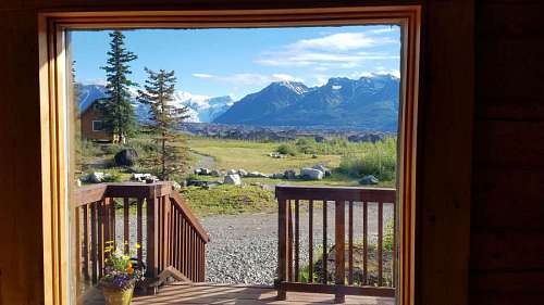 porch window door bungalow cottage balcony vacation wood mountain mountainside mountains peak snow landscape  exterior interior