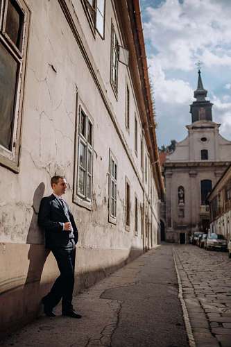outfit street standing town religion tower church architecture building businessman portrait outfit downtown sunglasses
