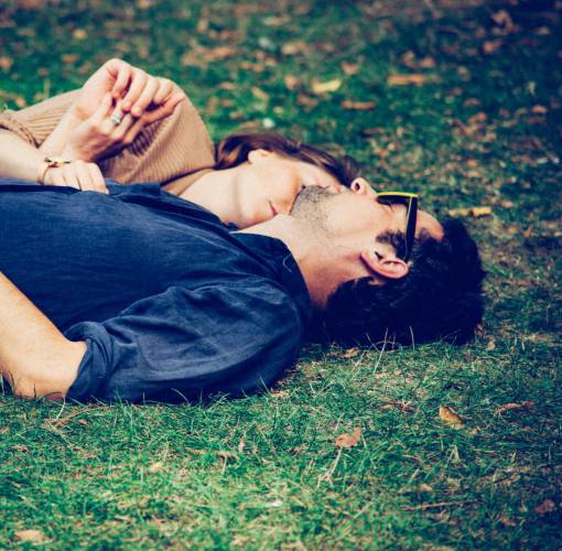 love Couple hugging and lying in a park