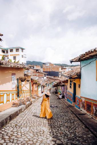 architecture Woman Walking Down a Colorful Street in Guatap?, Antioquia, Colombia ? Colonial Charm and Vibrant Architecture
