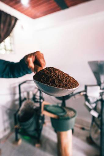 love Person Holding a Spoon with Freshly Ground Coffee ? Aromatic Brew Preparation and Coffee Culture Concept
