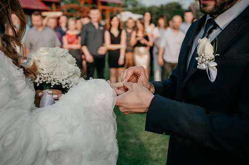 ceremony ring groom bouquet bride crowd married couple