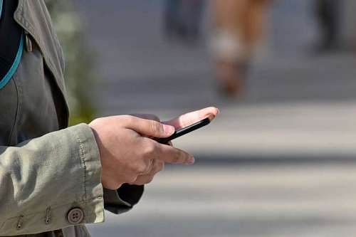 telecommunication communication mobile device phone outdoors telecommunication street blur hand