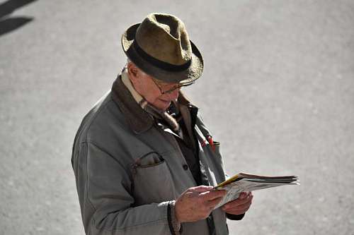 newspaper grandfather newspaper senior reading pensioner eyeglasses hat uniform