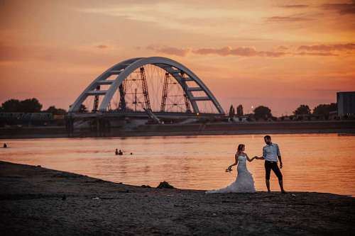 newlywed groom newlyweds harbour sunset beach dawn bride structure sea water