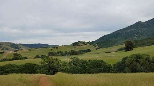 land landscape mountain countryside nature mountains grass tree range hill 