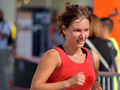 jogging pretty brunette running face track fitness woman cheerful portrait smile  jogging