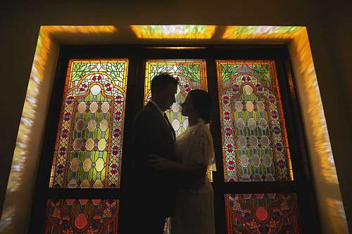 arts-culture-and-entertainment hugging fine bride stained glass marriage pretty hug illumination arts groom religion 