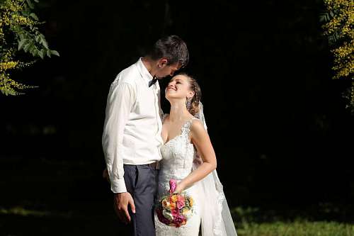 smiling groom shadow embrace couple bride forest 