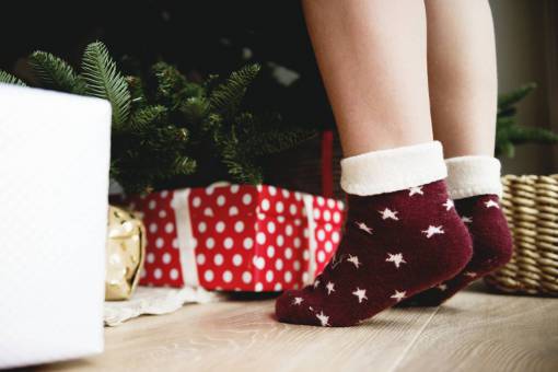 xmas Little boy in stockings looking for christmas gifts