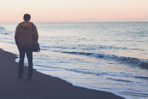 guy  man  people  bag  jacket  beach  sand