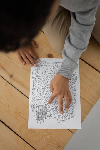 girl A girl solving a maze drawn on a paper