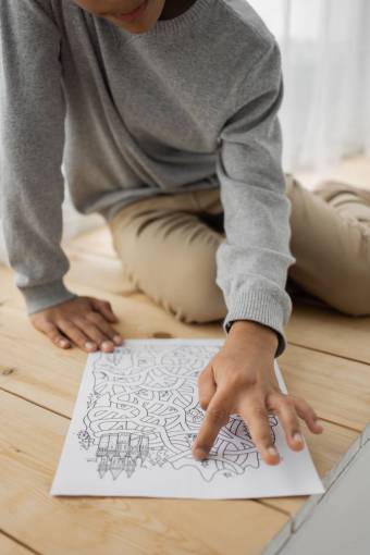 girl A girl solving a maze drawn on a paper