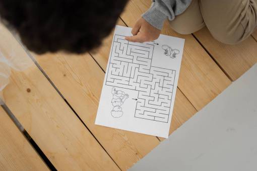 girl A girl solving a maze drawn on a paper