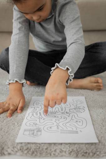 girl A girl solving a maze drawn on a paper