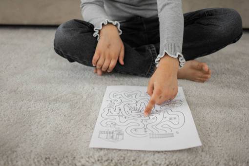 girl A girl solving a maze drawn on a paper