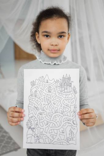 girl A girl solving a maze drawn on a paper