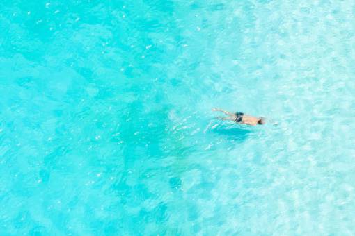 man swimming in the caribbean
