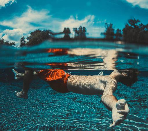 people  man  swimming  water  pool  tree  sky