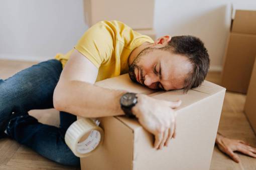 casual-clothing Sleeping man hugging a box while working