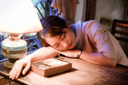 casual-clothing Young woman sleeping lying on her desk