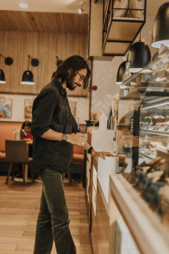 retail adult men man;buying;bakery;choosing indoors males casual clothing one person