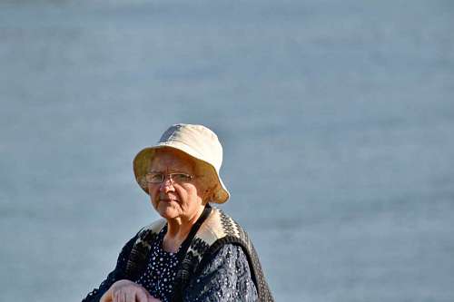 pensioner grandmother elderly face eyeglasses hat pensioner portrait looking water