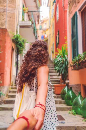 love Couple holding hands walking through the streets of Venice, Italy