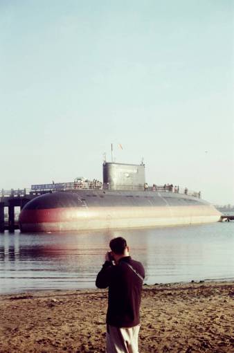 technology Man taking a photo of a submarine in the port