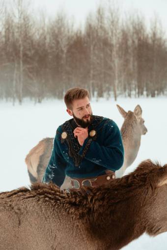 animals Man with deer in the snow