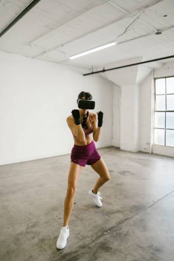smiling Woman practicing box with vr glasses