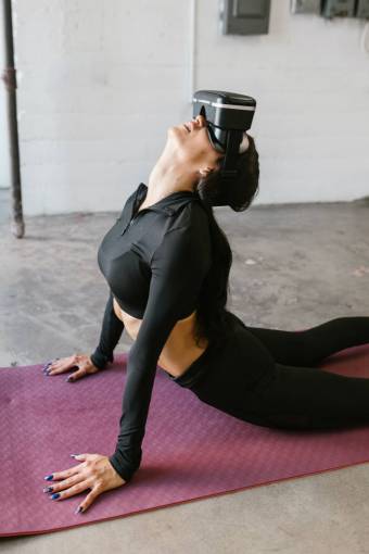 practice Woman practicing yoga with vr glasses