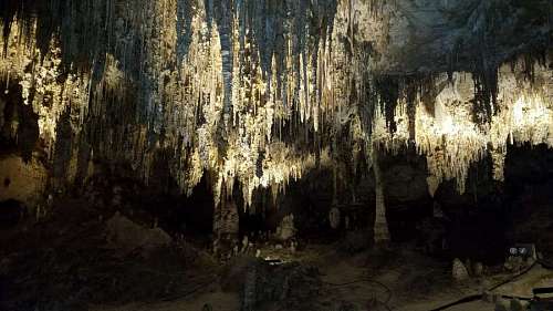 cave cave landscape limestone dark trees park forest wall rock