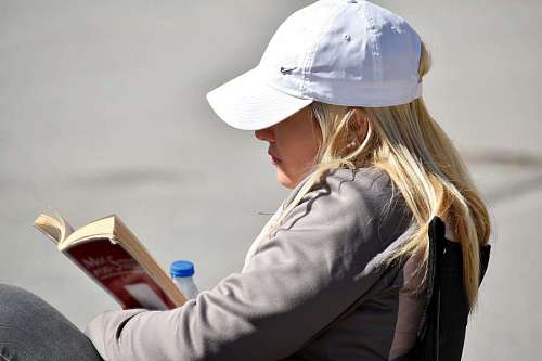 enjoyment reading outdoors gorgeous blonde hair hat portrait woman 