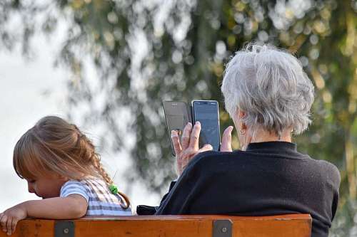 granddaughter mobile phone grandchild grandmother granddaughter entertainment relaxation togetherness leisure outdoors child