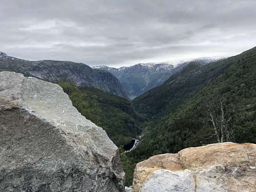mountain mountainside peak mountains landscape land snow nature rock water