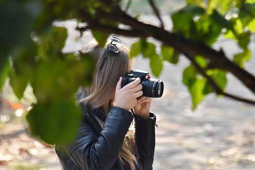 nature camera side photographer park lens outdoors leaf woman