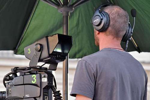 employee recording employee worker television lens outdoors photographer technology equipment 
