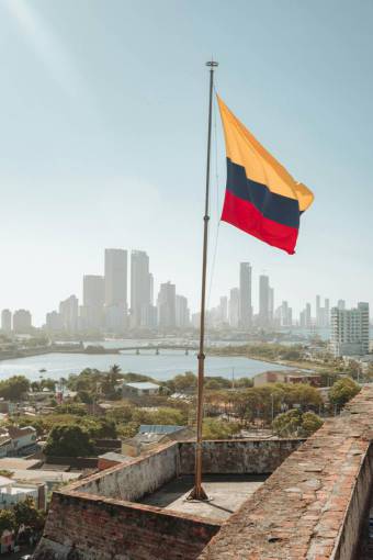 car Colombian Flag Waving Against Cartagena Skyline
