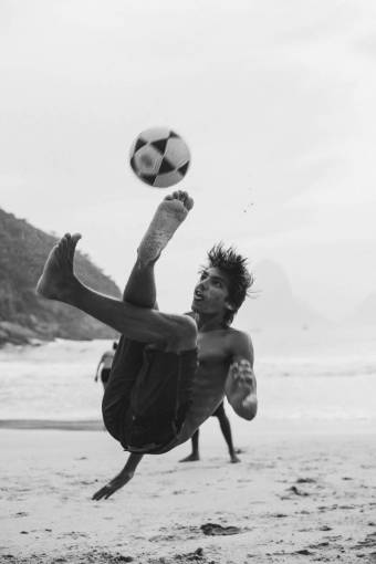 non-urban-scene Man Playing Football in Rio de Janeiro – Dynamic beach Soccer Scene
