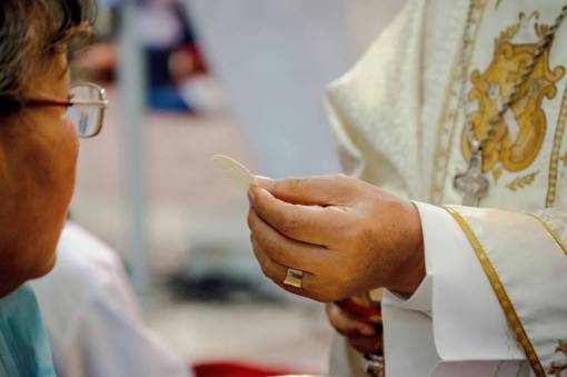 cat Woman Receiving Communion in a Church in Guayaquil, Guayas, Ecuador
