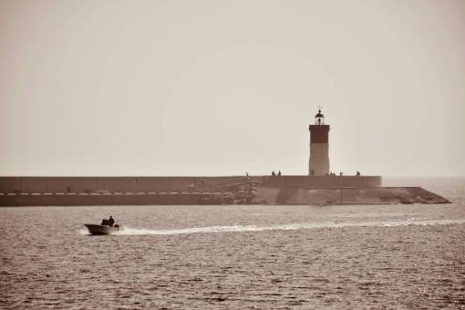 horizon Boat sailing near a lighthouse