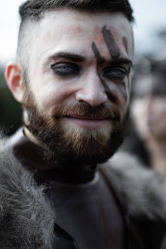 historical-architecture Portrait of a viking man with painted face looking at camera and smiling